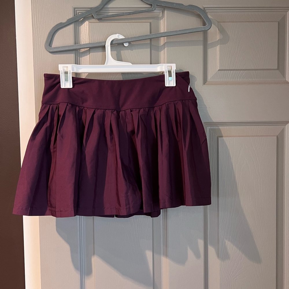 Head pleated tennis/golf skort. Built in shorts. Plum color. Size L.